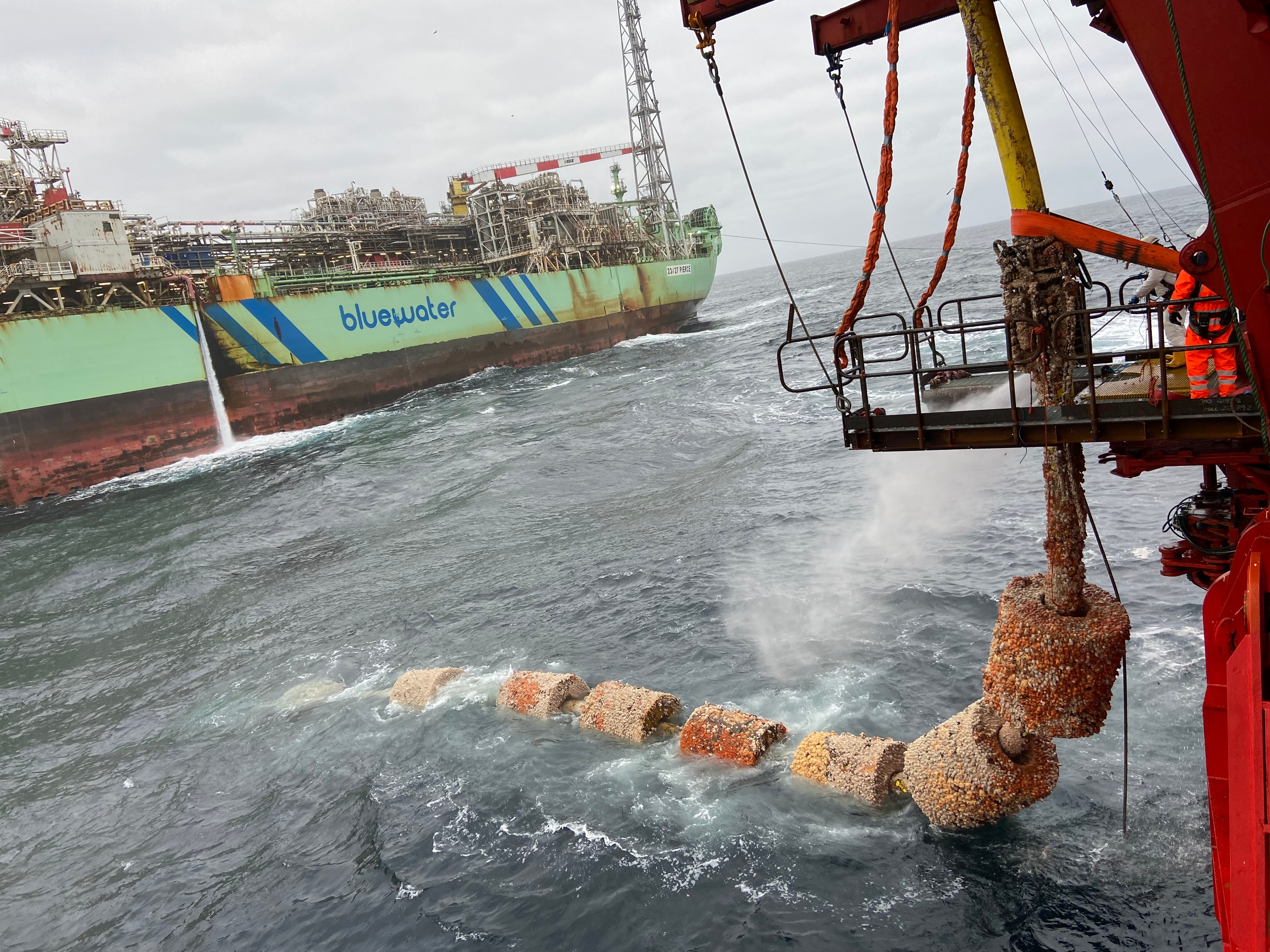 Offshore worker handling marine equipment on deck